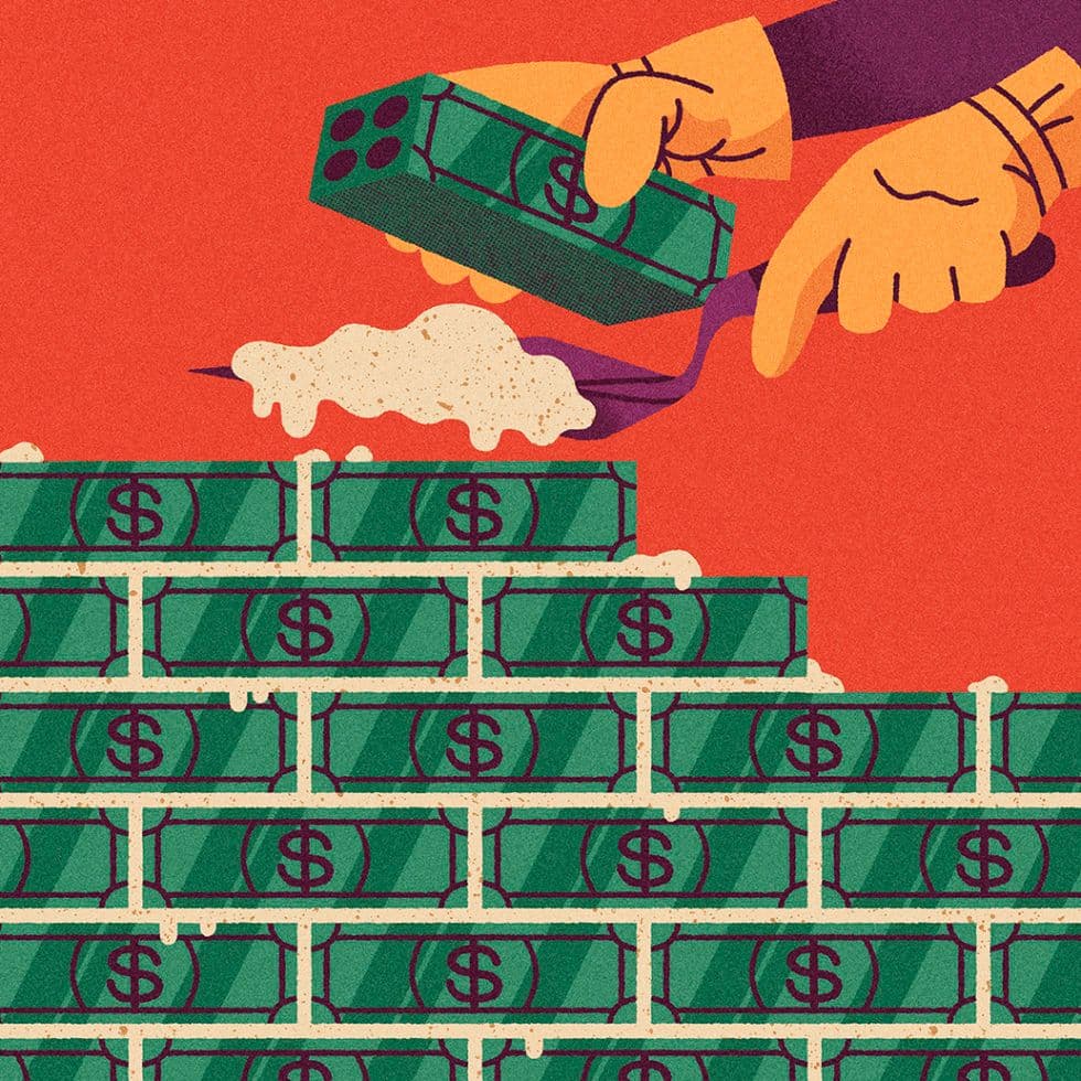 Hands stacking banknotes into a neatly built wall